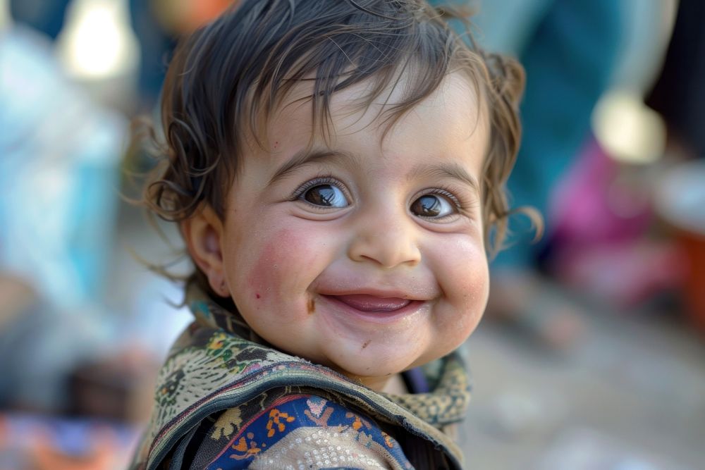 Refugee baby child naive smiling photography portrait clothing.