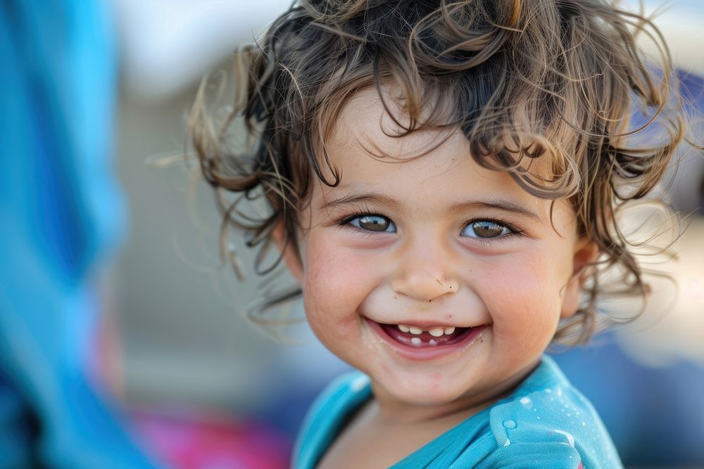 Refugee baby child naive smiling photography portrait laughing.