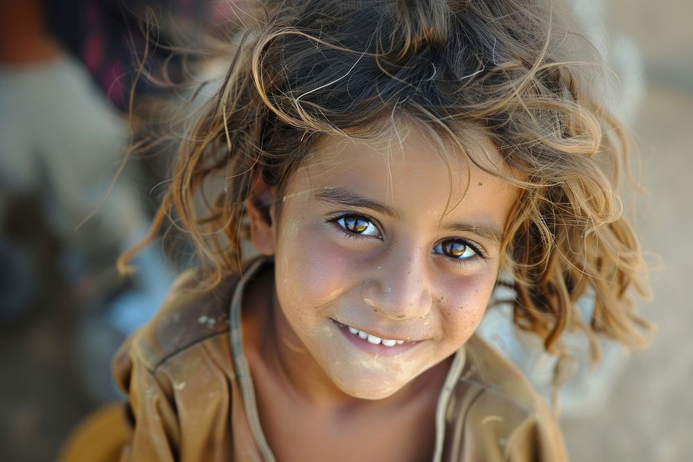 Refugee child girl naive smiling photography portrait shoulder.