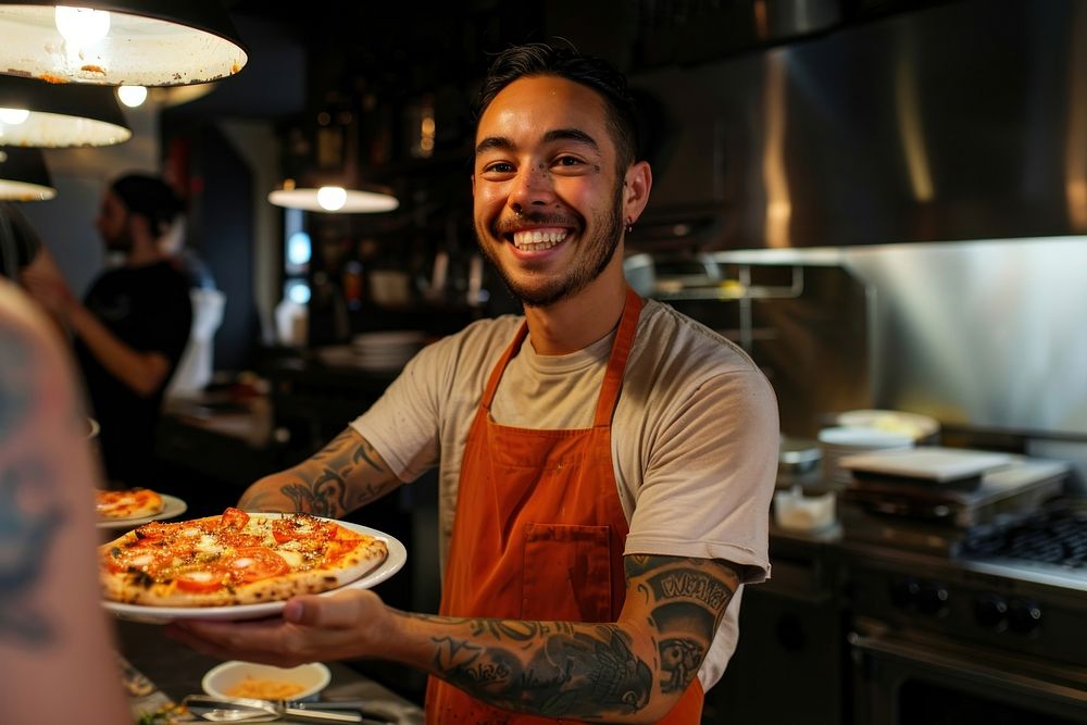 An attractive young chef tattoo pizza person.