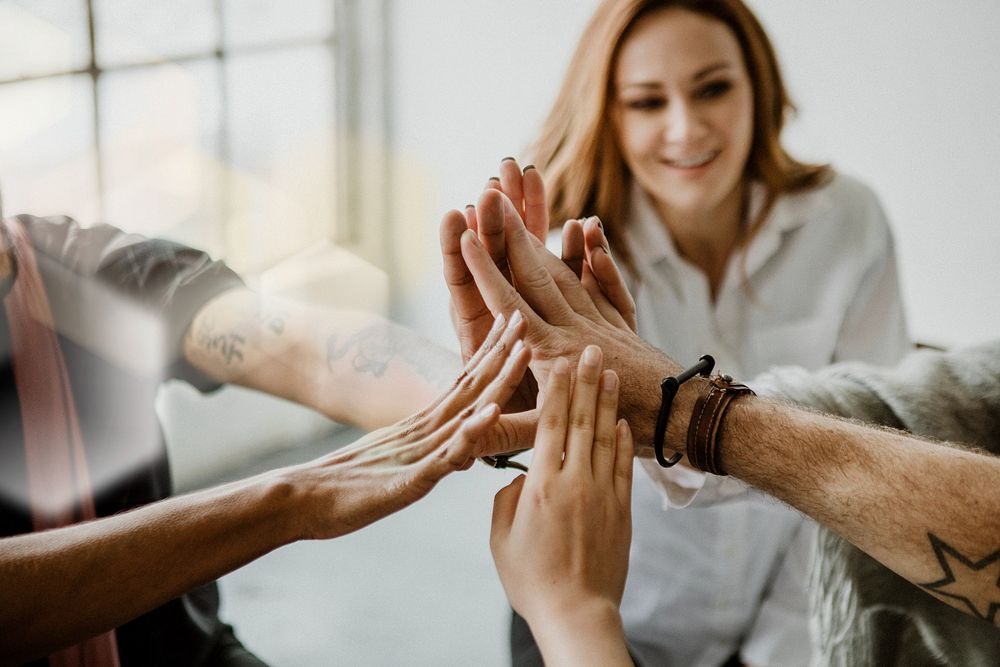 Group of diverse team joining hand in the middle