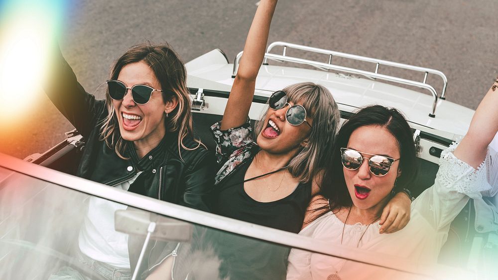 Boho girls on convertible car, summer road trip to the festival