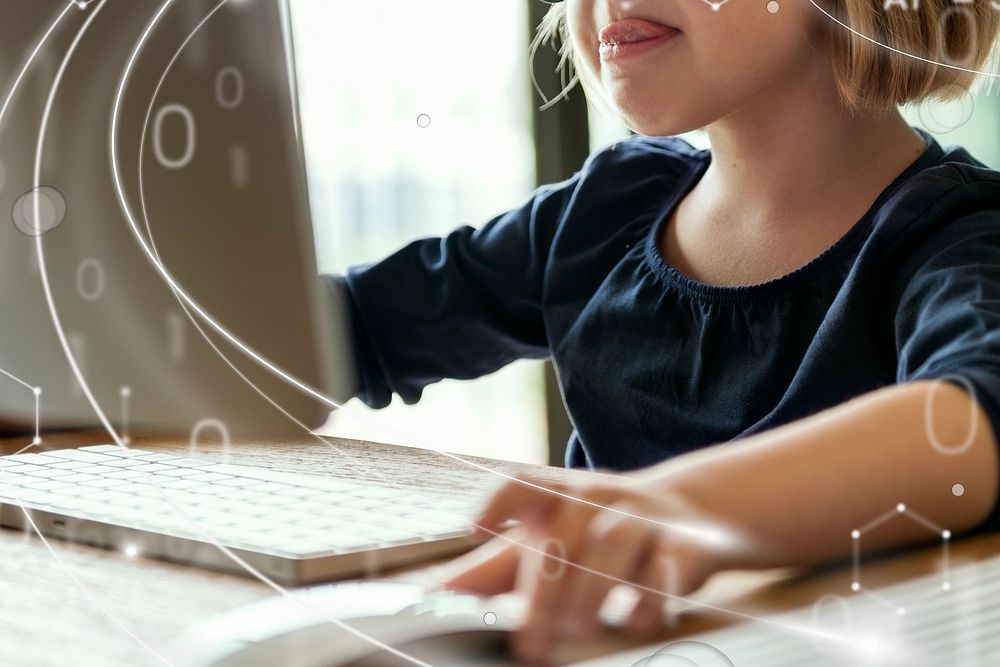 Little girl playing on a computer