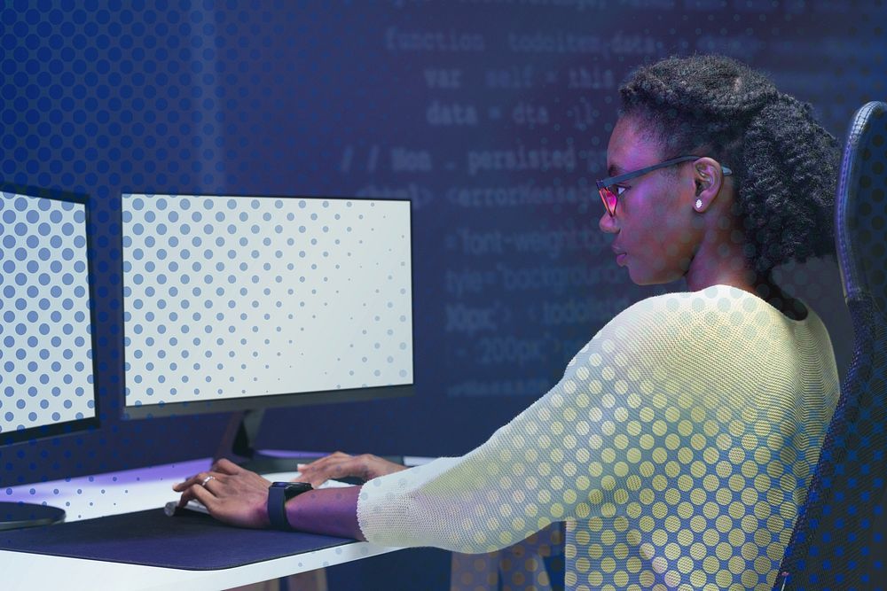 Female IT programmer working on blank screen computer