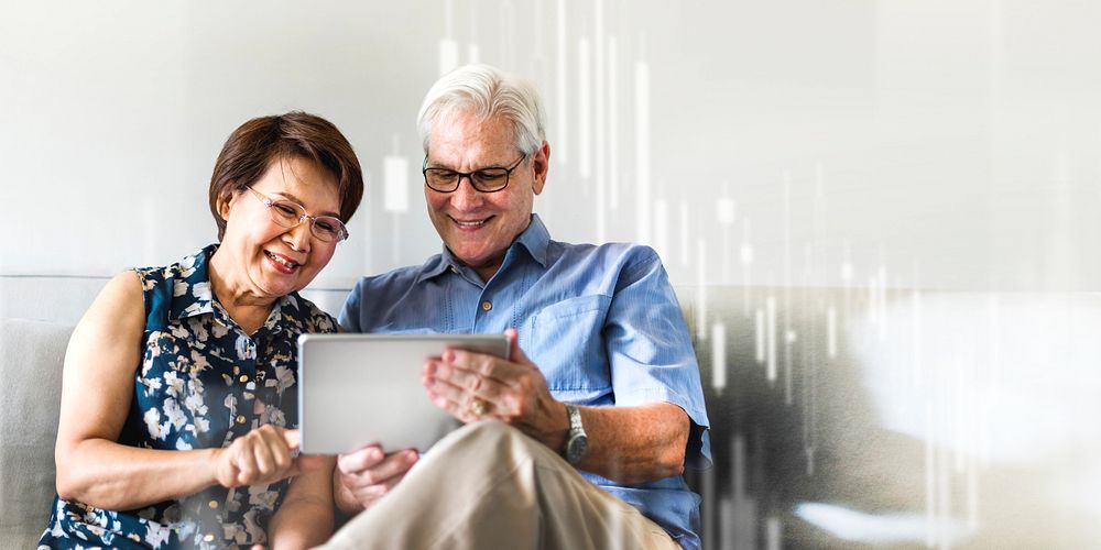Senior couple using a digital device in a living room