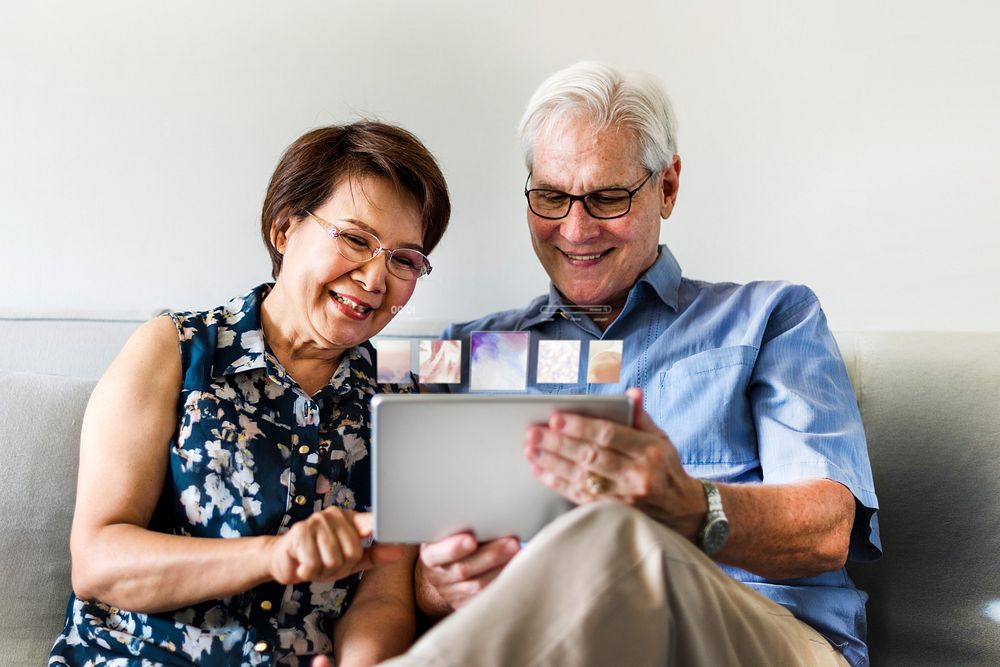Senior couple using tablet remix