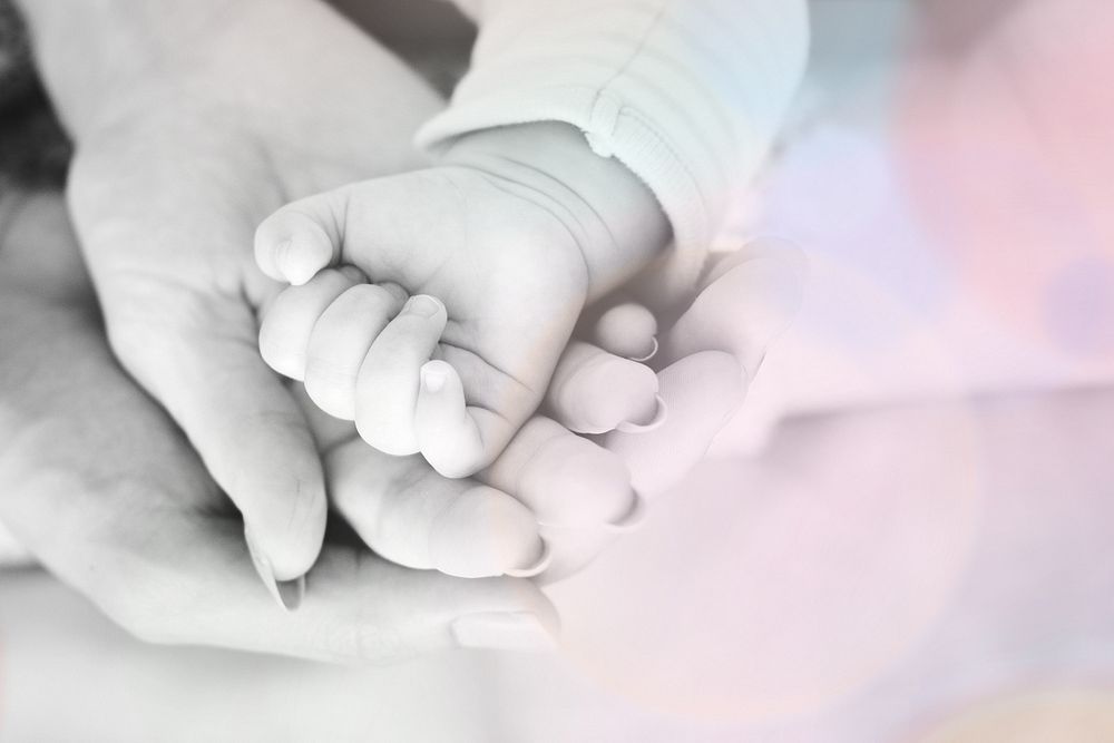 Closeup of family hands holding each other with love