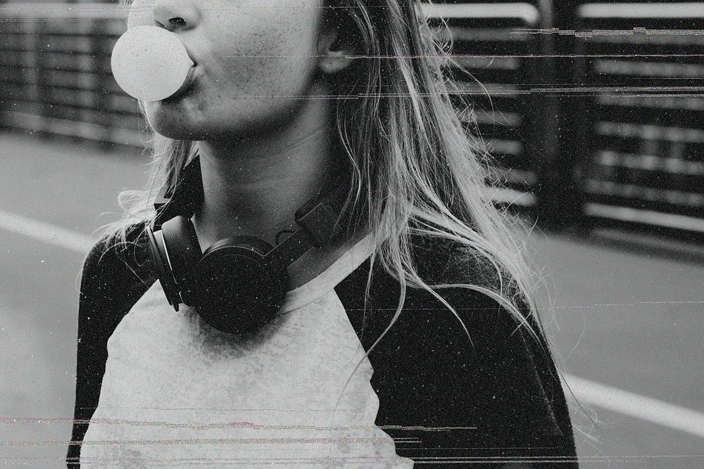 Carefree young woman blowing gum
