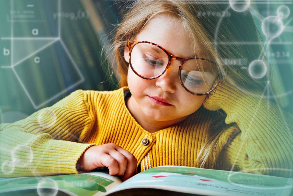 Little girl wearing eyeglasses reading a story
