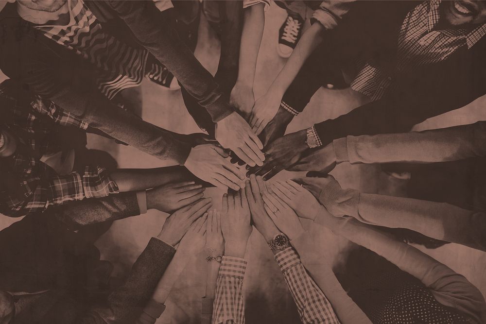 Aerial view of diverse people stacking hands in the middle