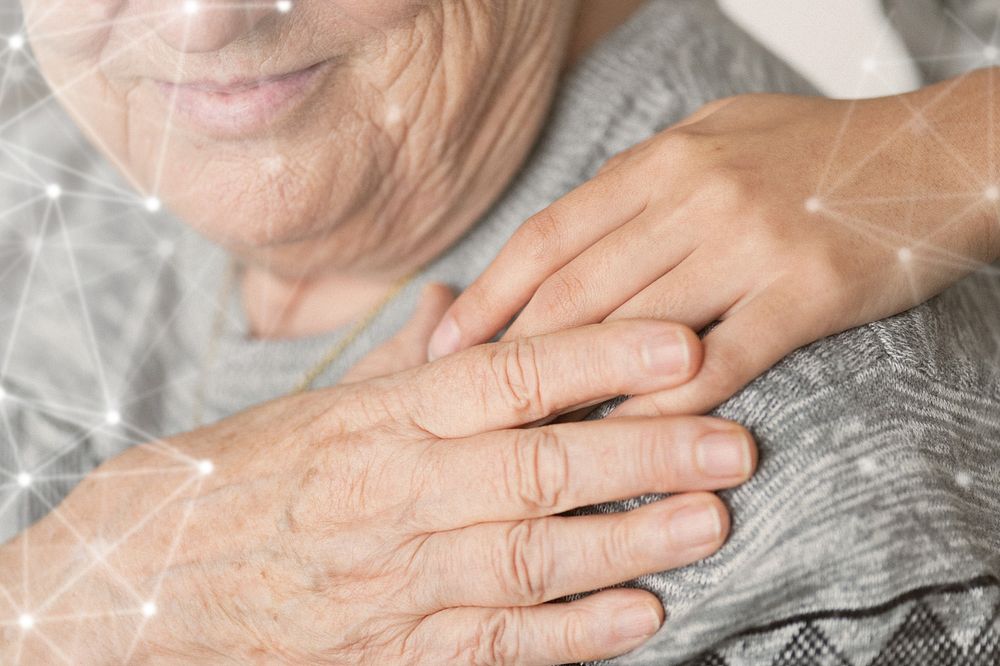 Elderly holding a hand on the shoulder