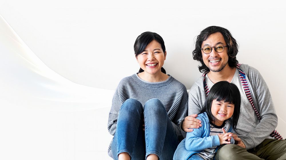 Happy Asian family sitting on floor