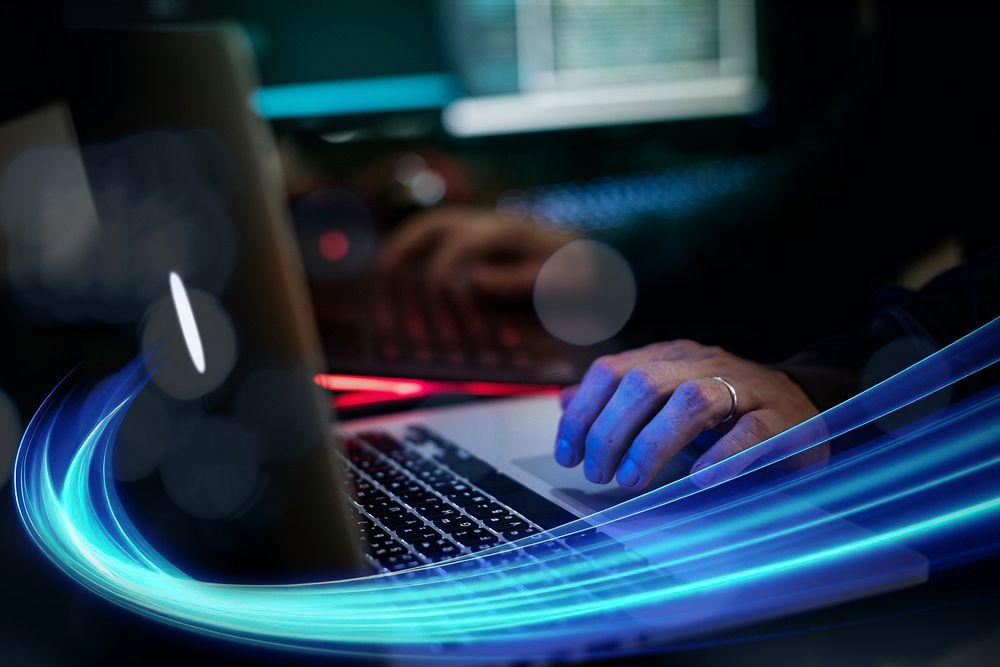 Man working on laptop in dark