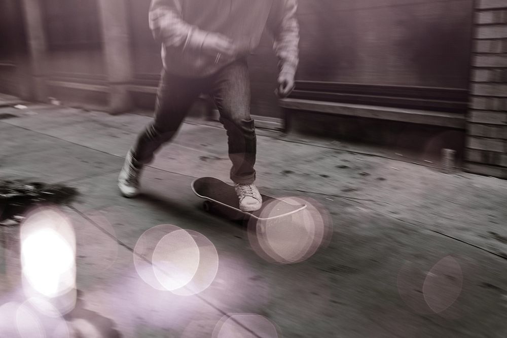 Man skating in city grayscale
