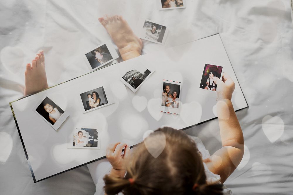Little girl looking her family photo in album