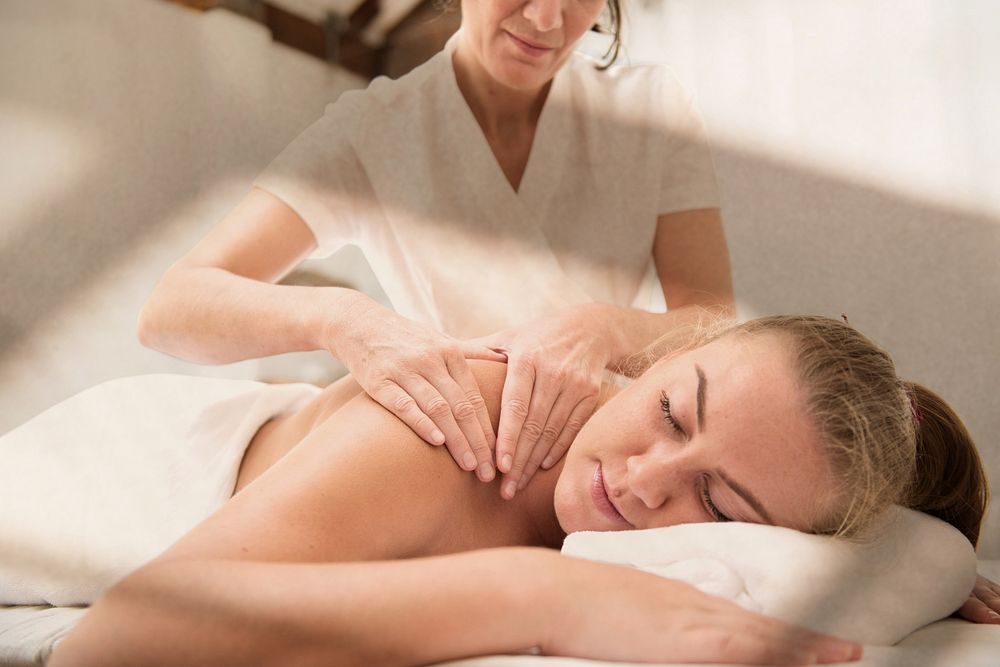 Woman having massage, spa retreat