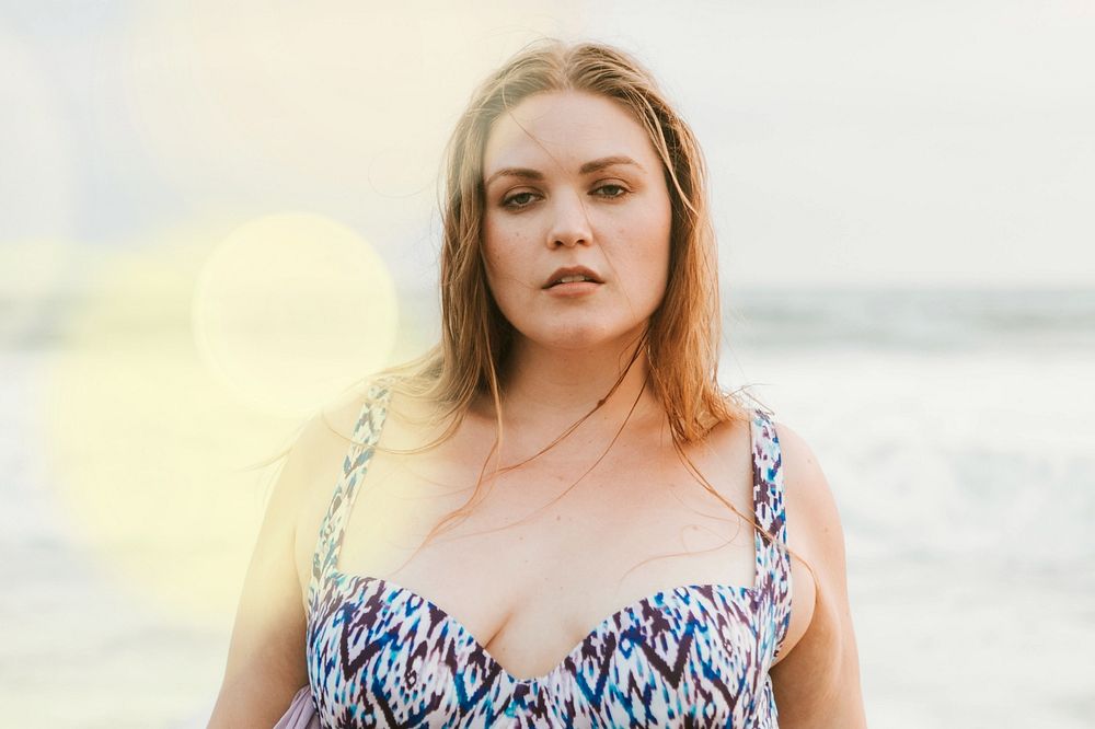 Confident blond plus size woman at the beach
