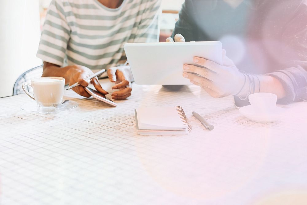 Colleagues discussing their work on a tablet