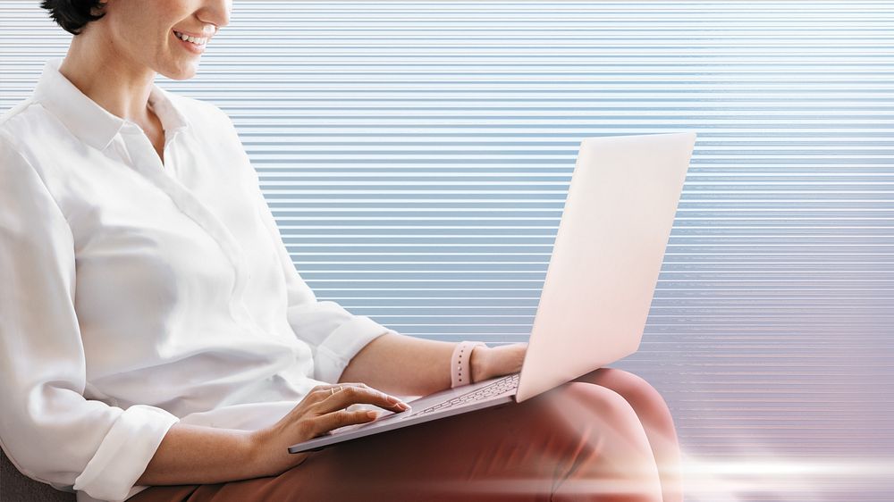 Cheerful woman working on laptop