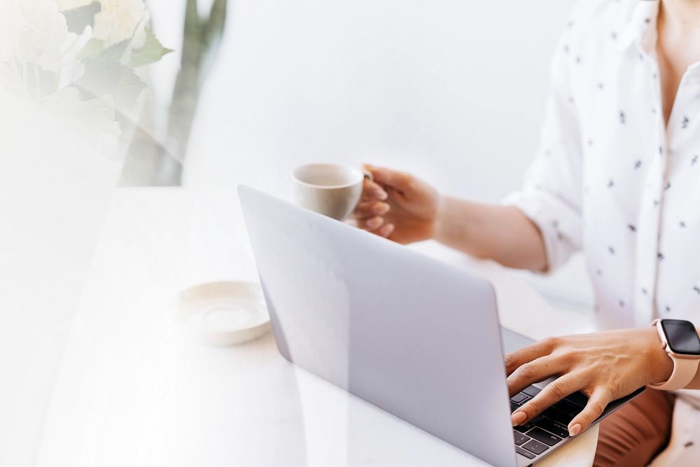 Businesswoman drinking coffee while working at home