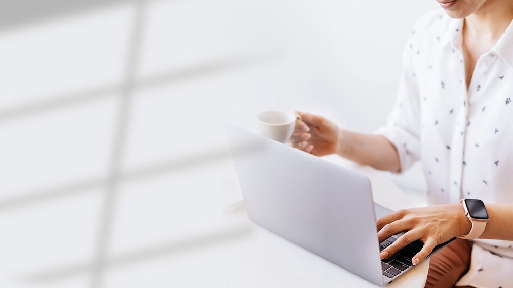 Businesswoman drinking coffee while working at home