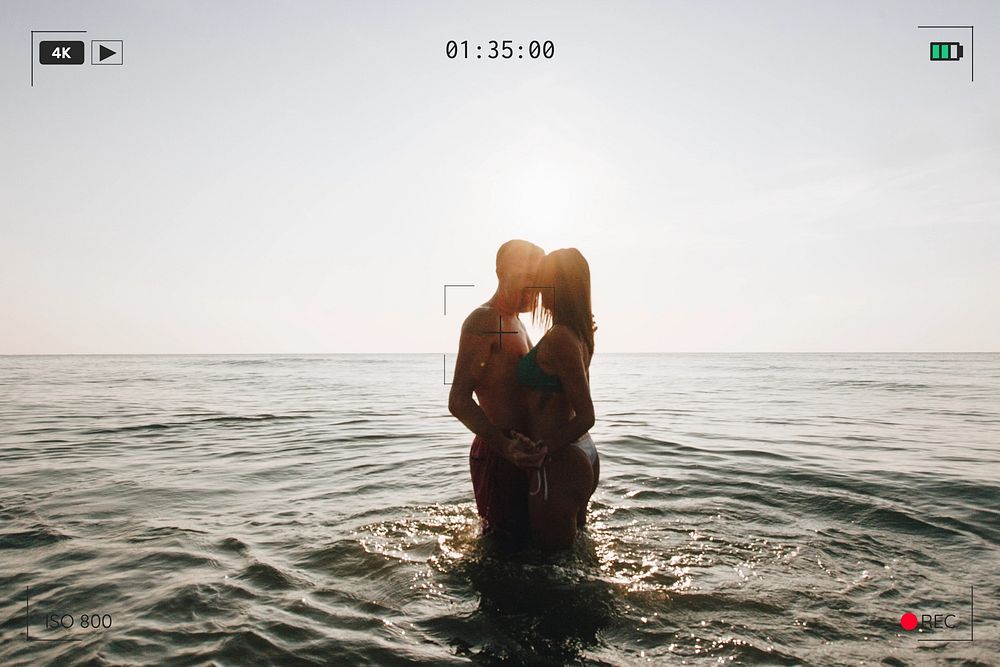 Romantic couple in the sea at sunset