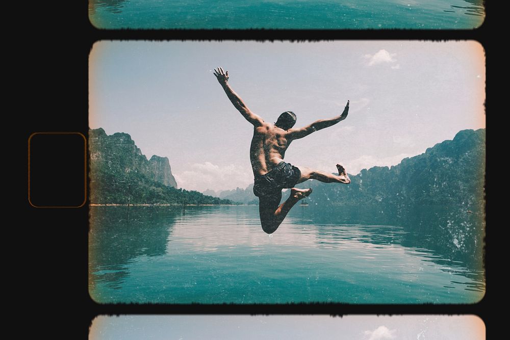 Man jumping with by a lake