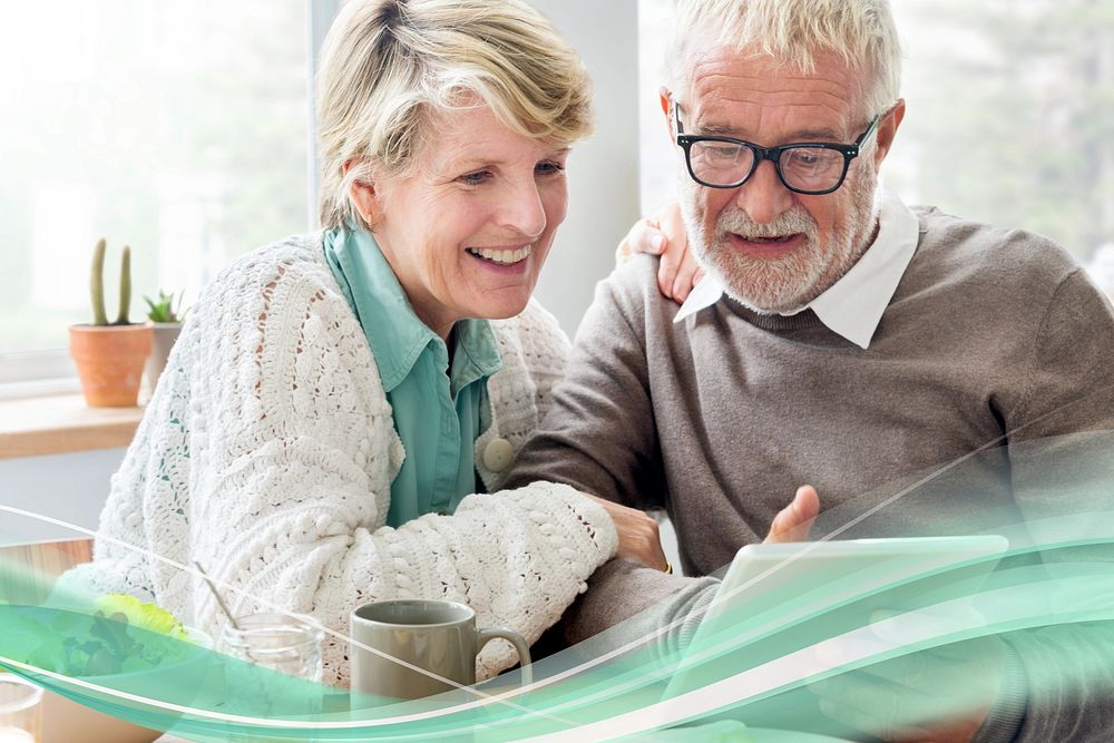 Happy senior couple using tablet