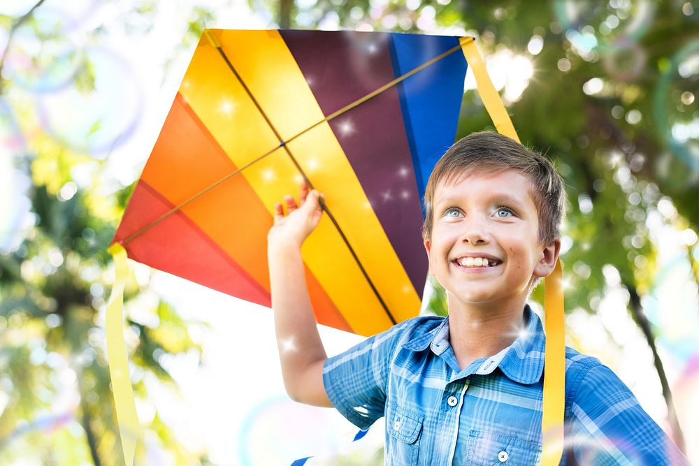 Boy playing with a colorful kite