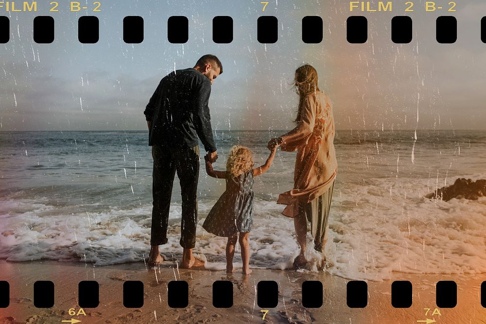 Happy family holding hands at the beach on vacation