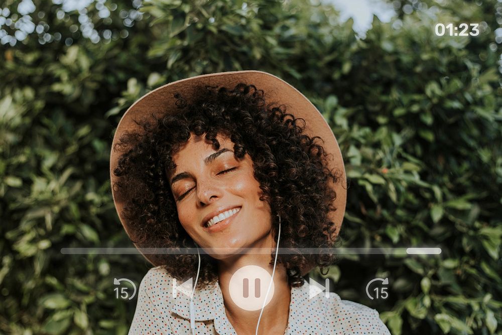 Beautiful woman listening to music in a botanical garden remix