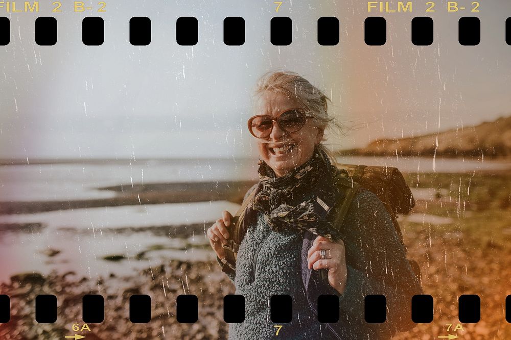 Senior tourist woman walking at the beach