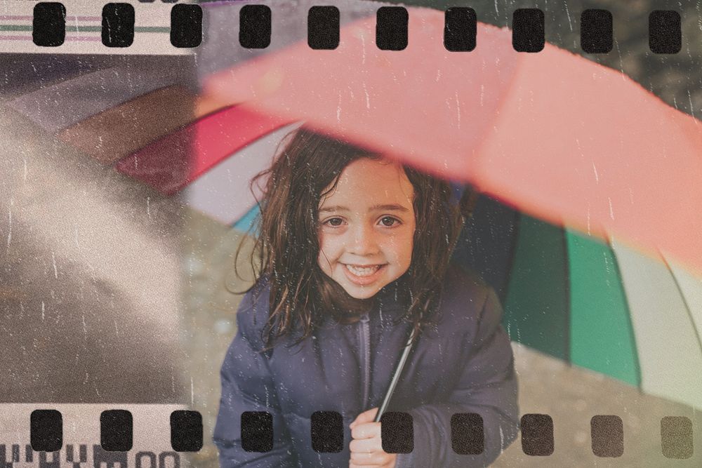 Little girl smiling with an umbrella