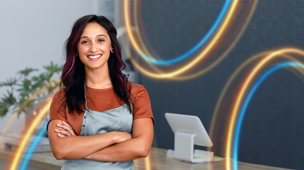 Smiling female small business owner at a cash register