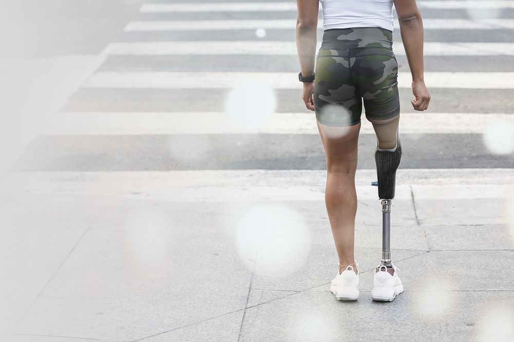 Woman with prosthetic standing by the crosswalk remix