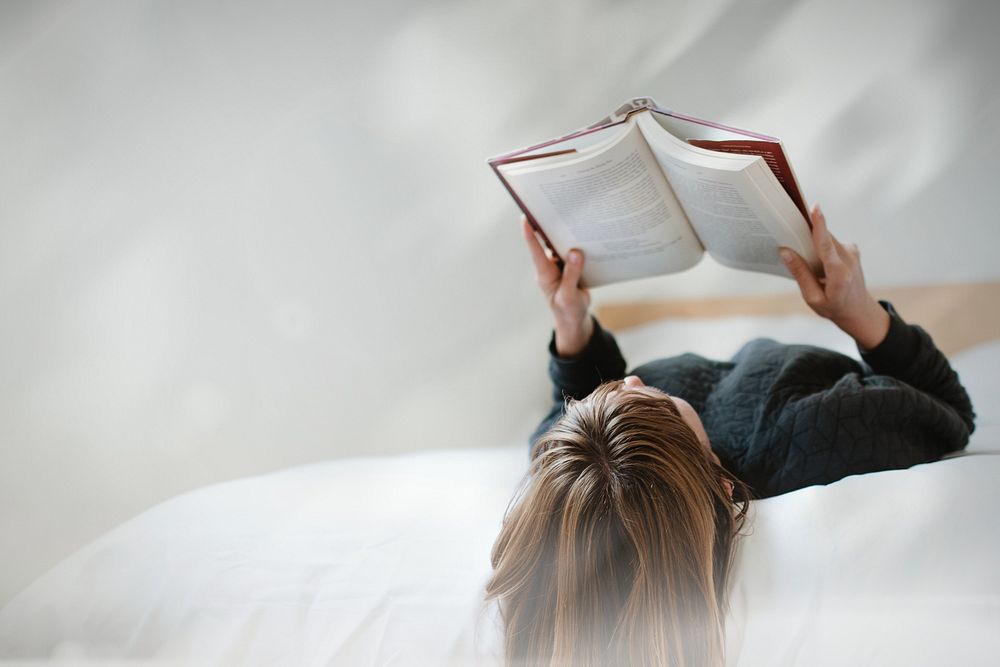 Woman reading book on bed remix