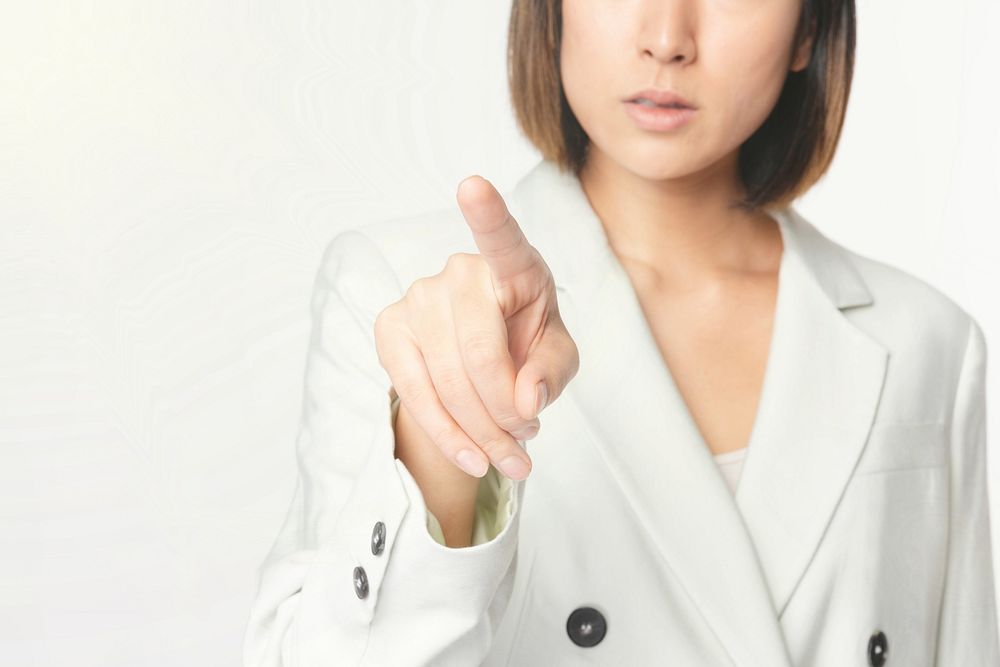 Asian businesswoman touching virtual screen