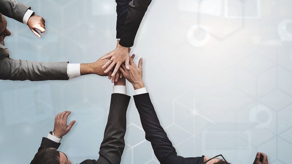 Businessmen stacking hands in middle