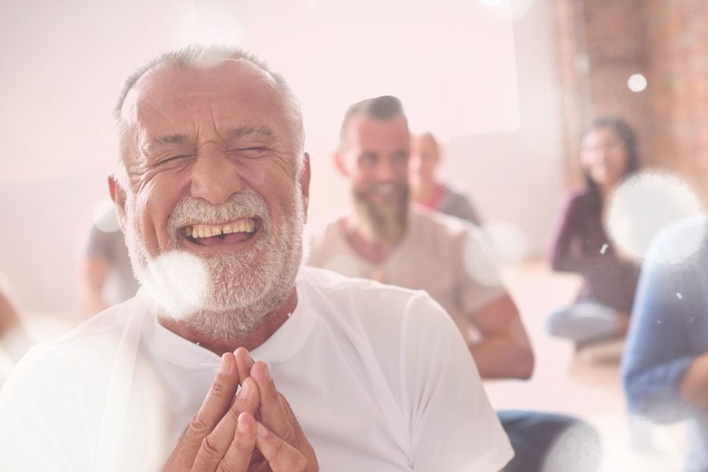 Smiling old man in yoga class