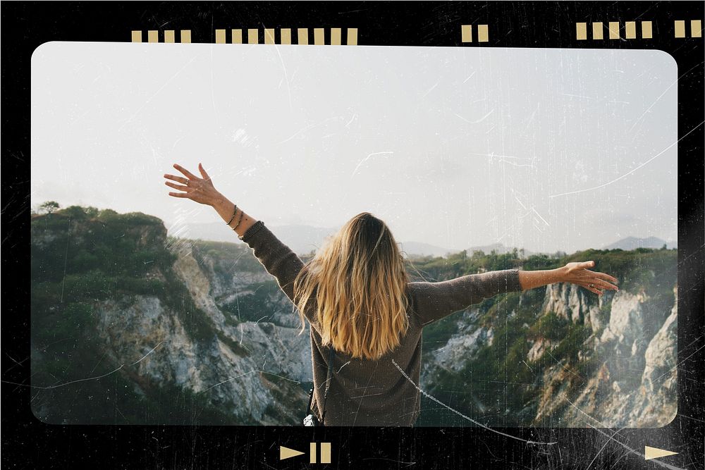 Carefree woman arms outstretched on the mountain