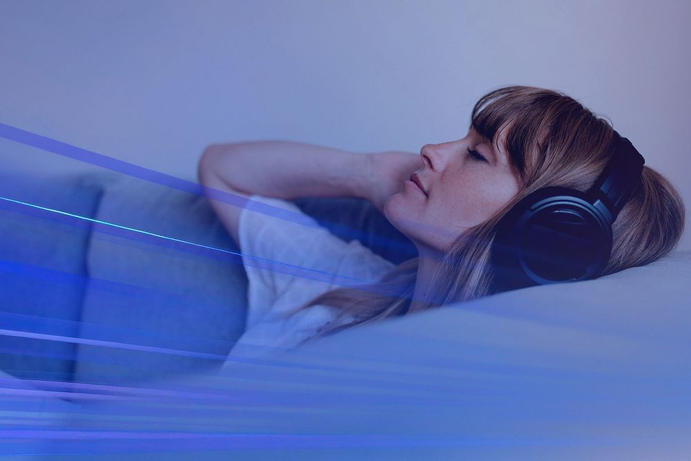 Woman listening to music during coronavirus quarantine on a couch