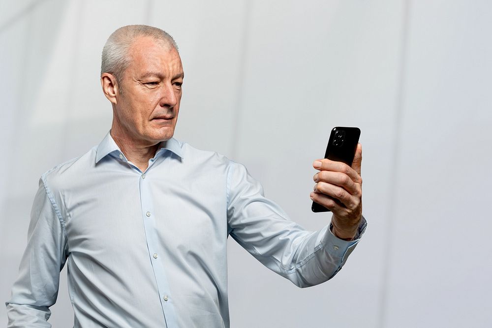 Businessman scanning his face to unlock phone security technology