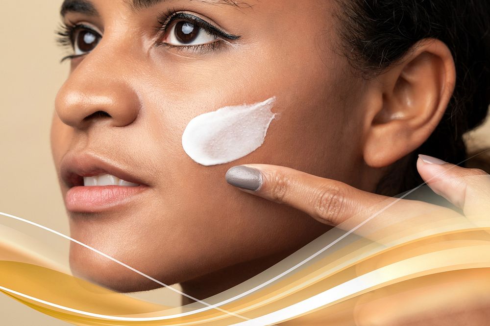 Closeup of a beautiful woman using a moisturizing cream for skincare routine