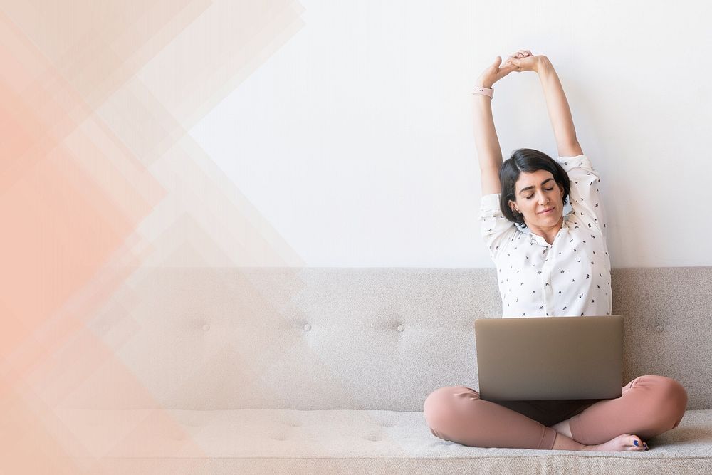 Woman stretching after working on laptop