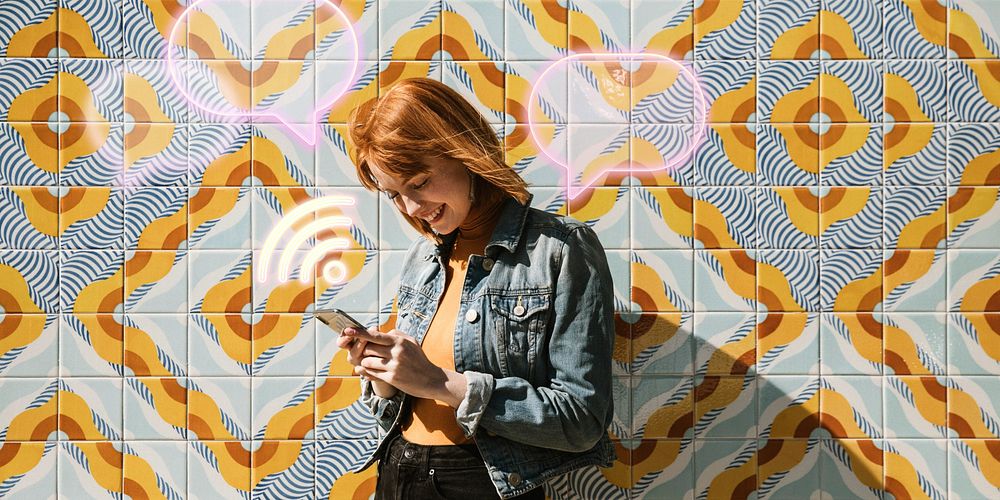 Woman using her phone at a modern patterned wall