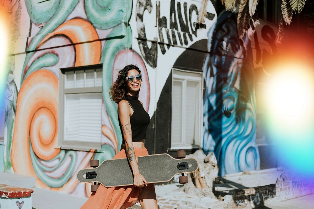 Cool woman with a longboard in town