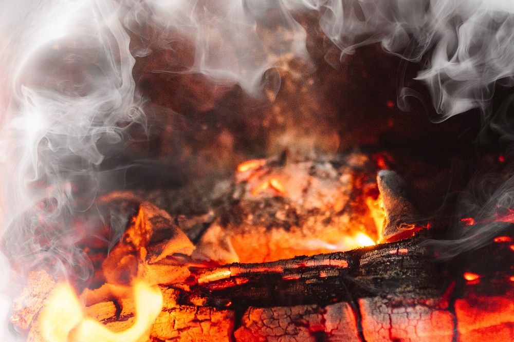 Burning firewood in a fireplace black smoke