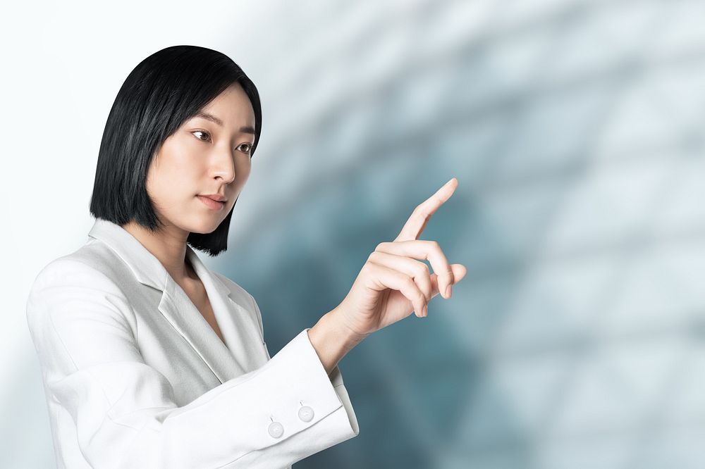 Asian businesswoman touching virtual screen remix