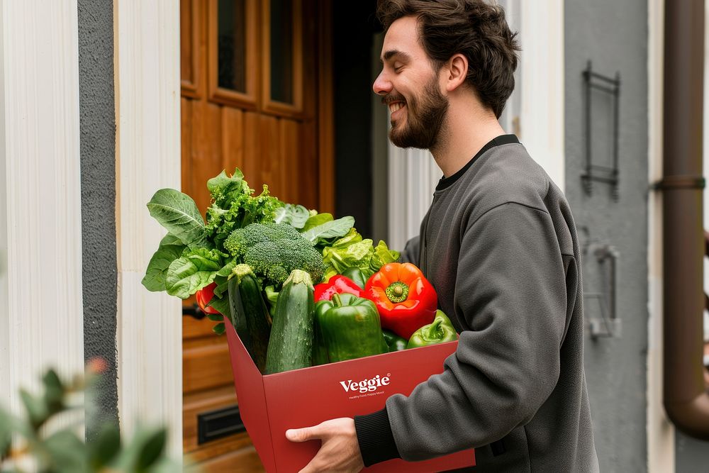 Man carrying red vegetable paper box