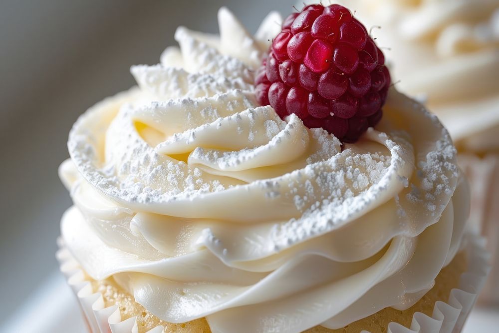 Vanilla cupcake with fluffy buttercream frosting raspberry dessert produce.